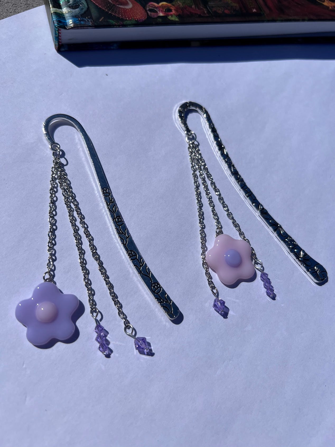 Adorable Baby Pink Stained Glass Fused Daisy and Crystal Bead Metal Bookmark! Carefully crafted with crystal beads and a stained glass daisy to elevate the cuteness vibes as you read!