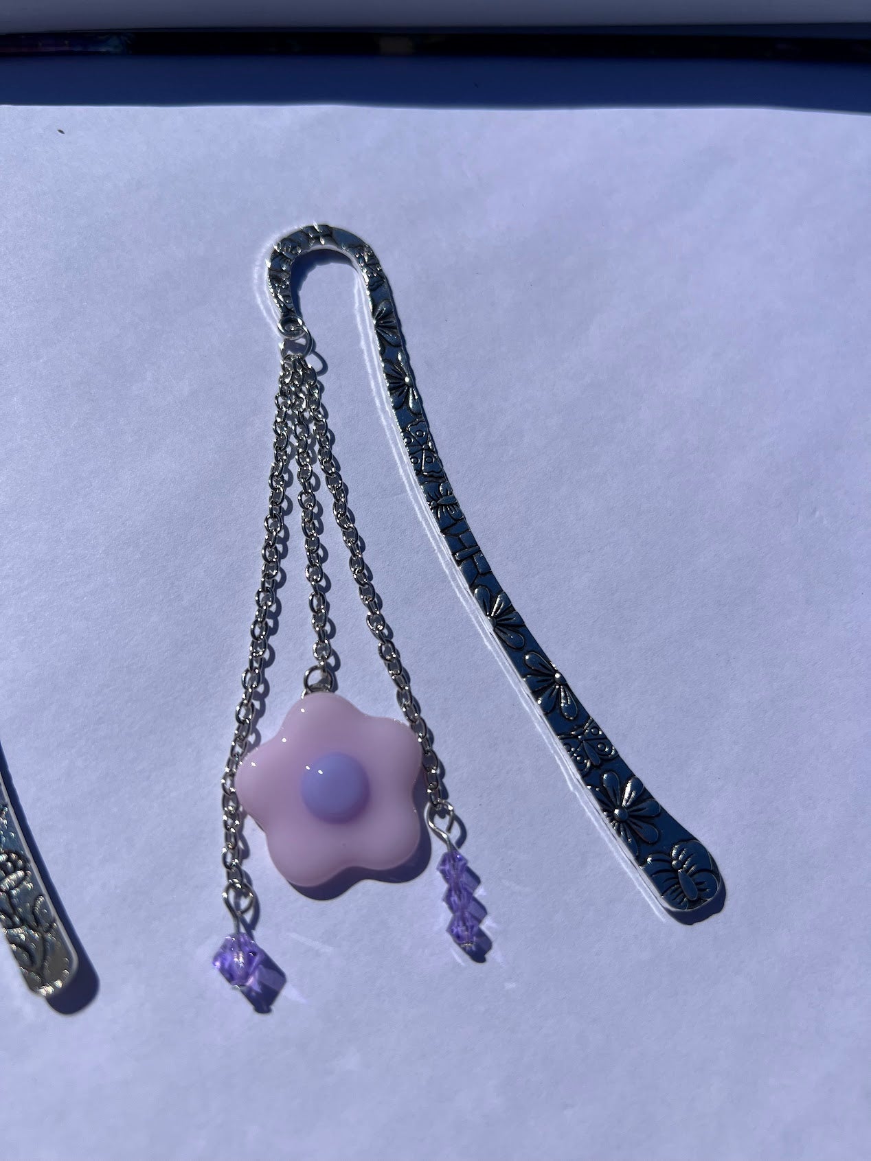 Adorable Baby Pink Stained Glass Fused Daisy and Crystal Bead Metal Bookmark! Carefully crafted with crystal beads and a stained glass daisy to elevate the cuteness vibes as you read!